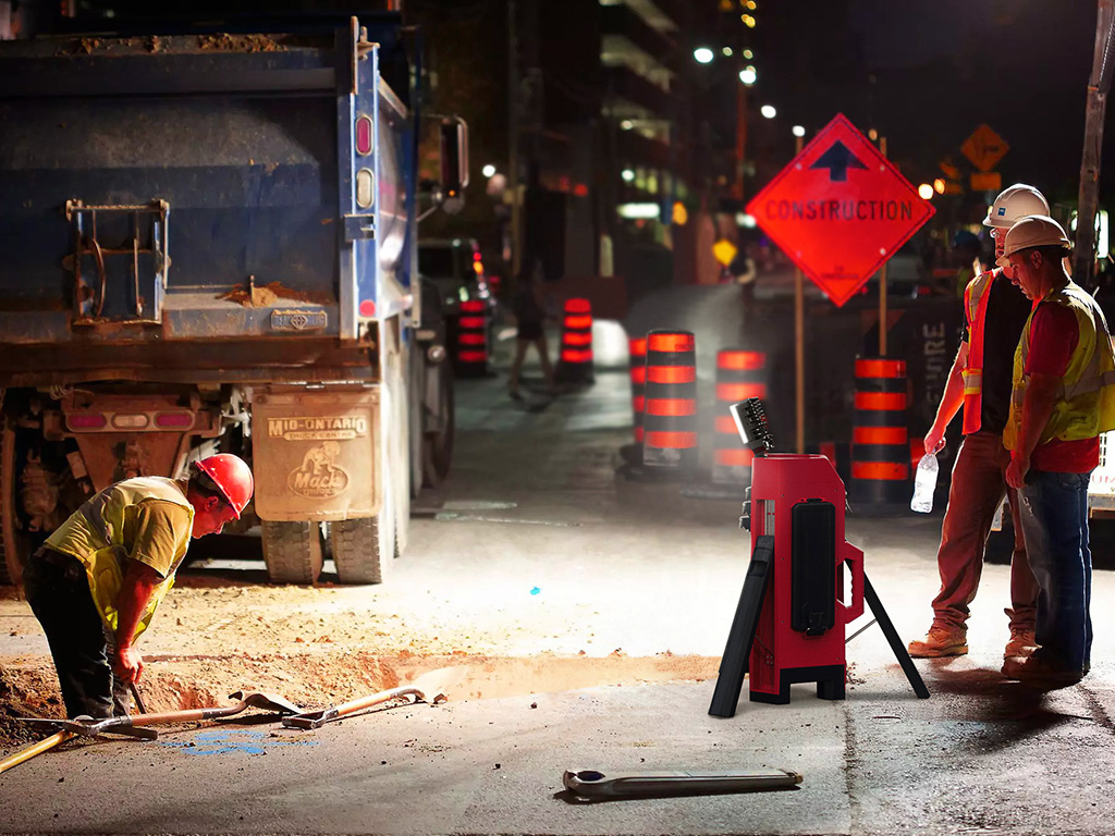 Men at work with a portable site light